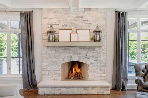 gorgeous stone fireplace with wood mantel