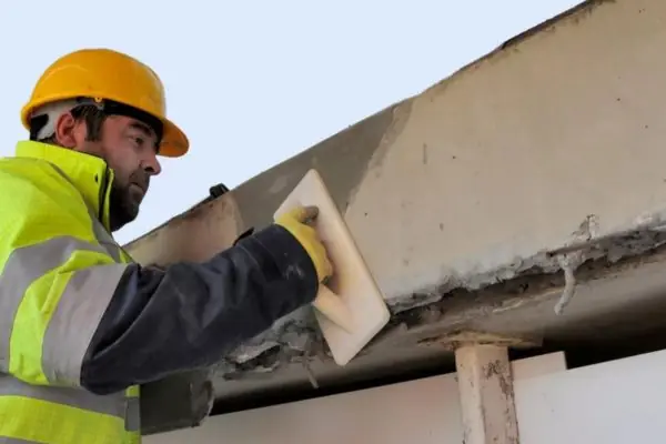 a man repairing spalling concrete