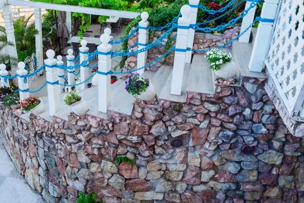 light steps with blue chain railings and masonry wall outdoor
