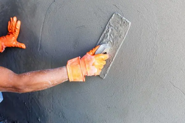 construction worker by wall of house