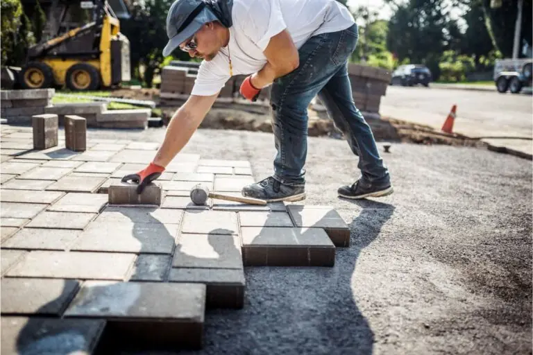 mason worker installing paving stones