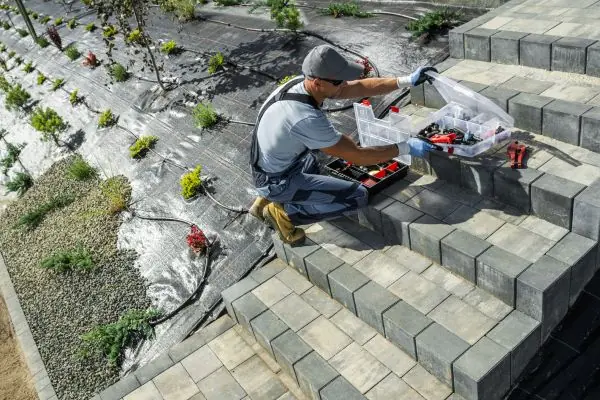 masonry worker decorating stone in the garden