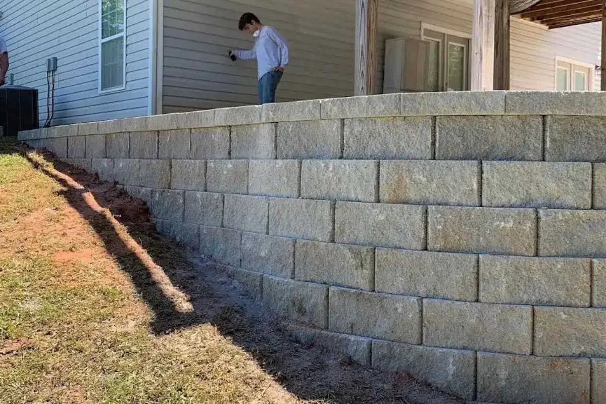 backyard retaining wall with man on side