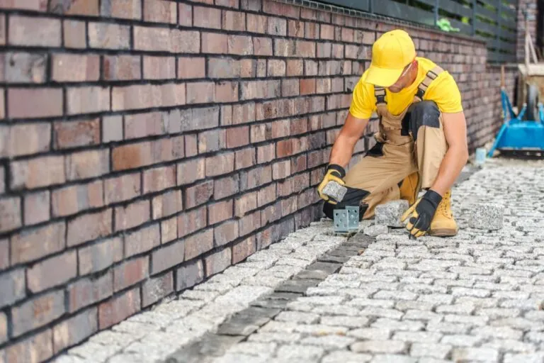 professional contractors laying paving stones