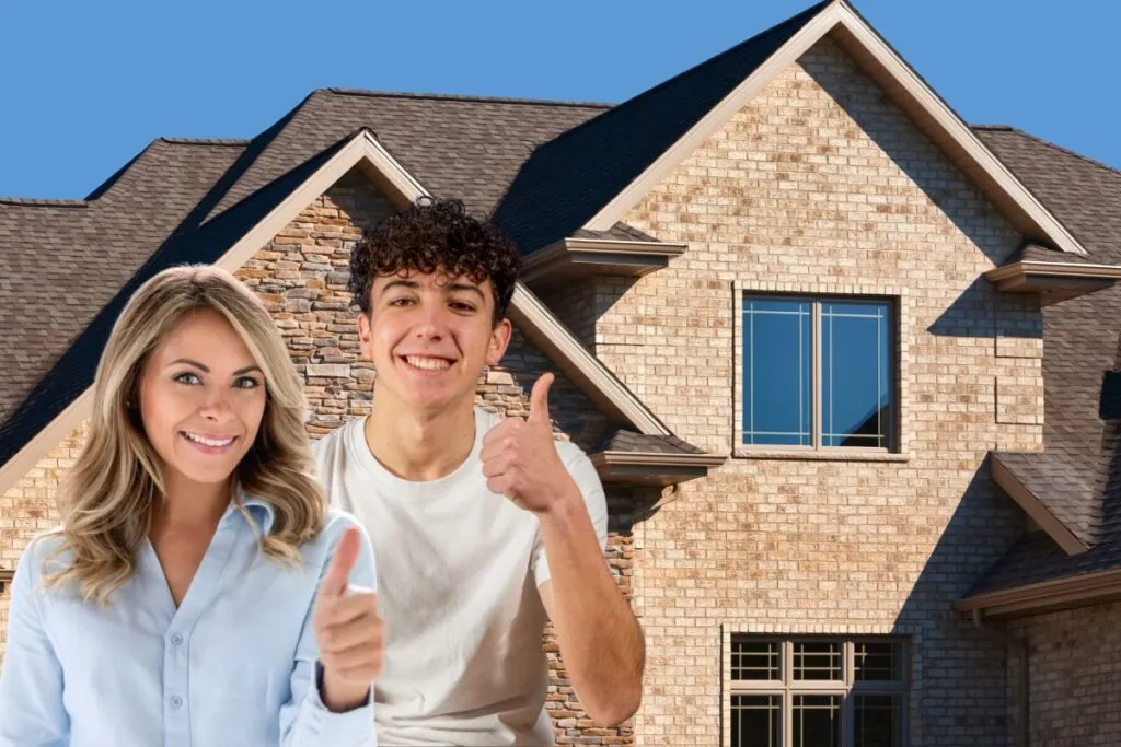 smiling couple thumbs up outside their new brick house