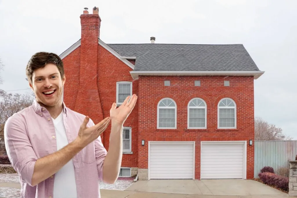 happy man standing in front of brick house