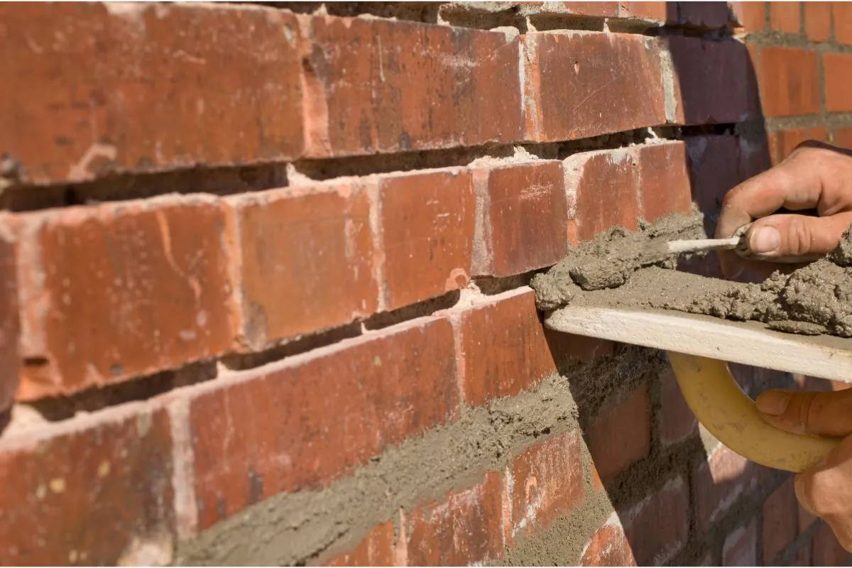 bricklayer repointing old bricks