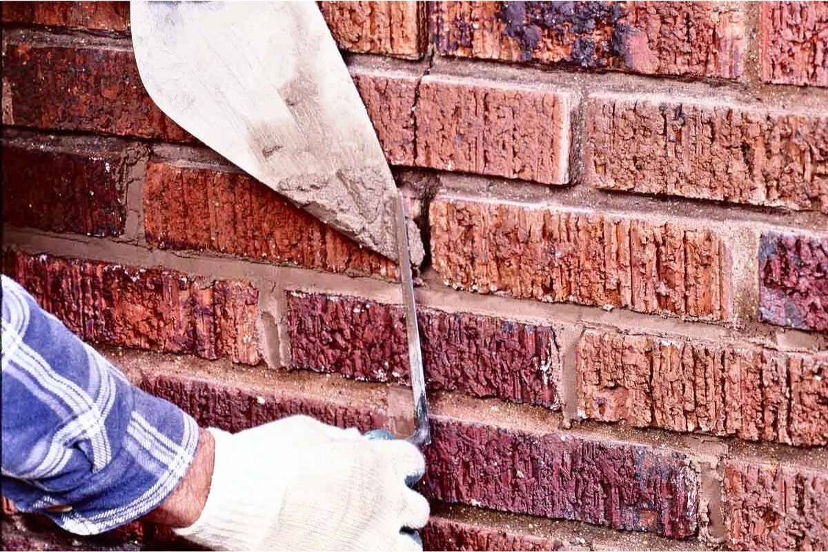 masonry contractor working on mortar joint repointing