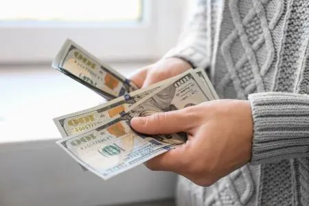 a woman counting dollar bills